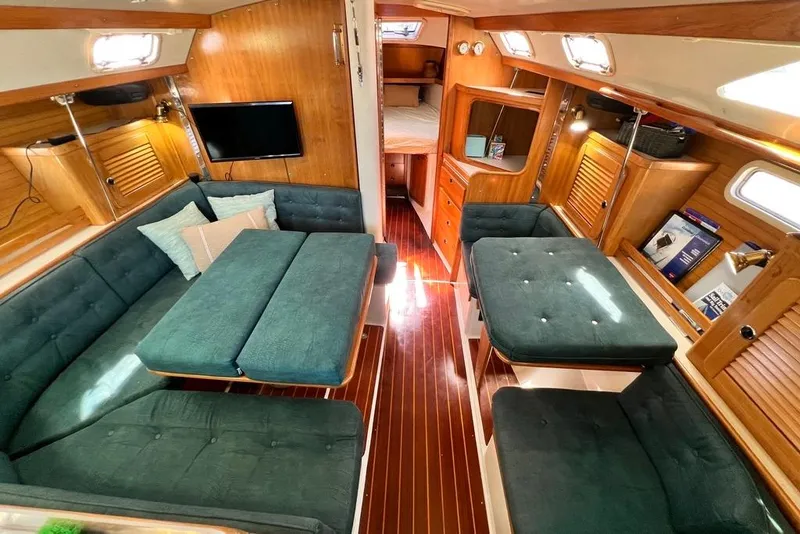 Slide: The Image of Interior of a 1999 Catalina 36 MkII sailboat with cozy seating and wooden finishes. - 42