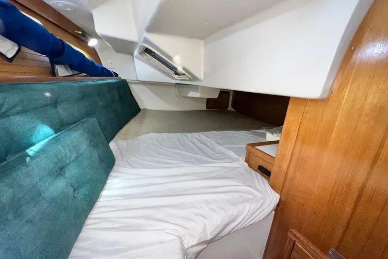 Slide: The Image of Cozy cabin interior of 1999 Catalina 36 MkII sailboat with teal cushions and wooden accents. - 47