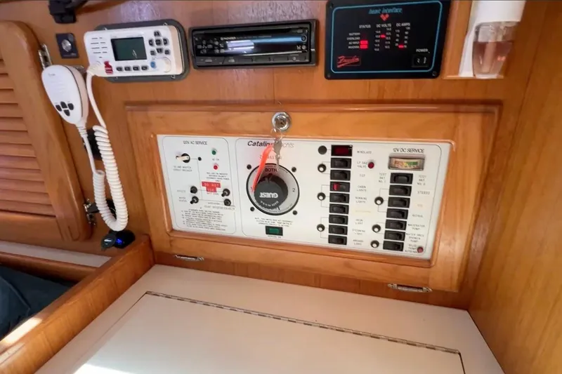 Slide: The Image of Control panel of a 1999 Catalina 36 MkII sailboat, featuring various switches and gauges. - 49