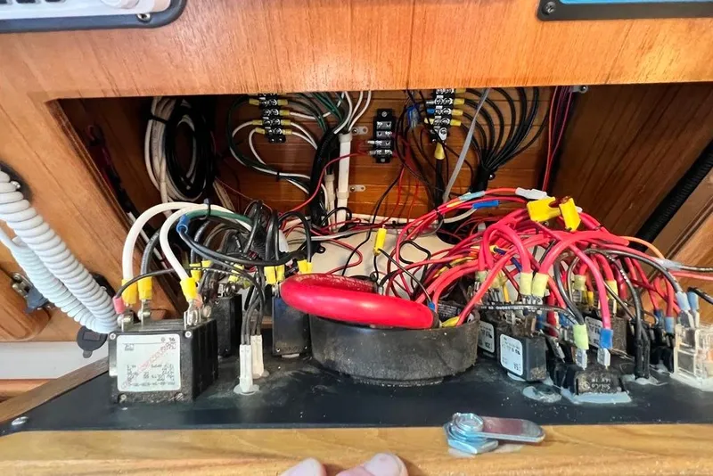 Slide: The Image of Electrical wiring panel inside a 1999 Catalina 36 MkII sailboat, showcasing complex connections. - 50