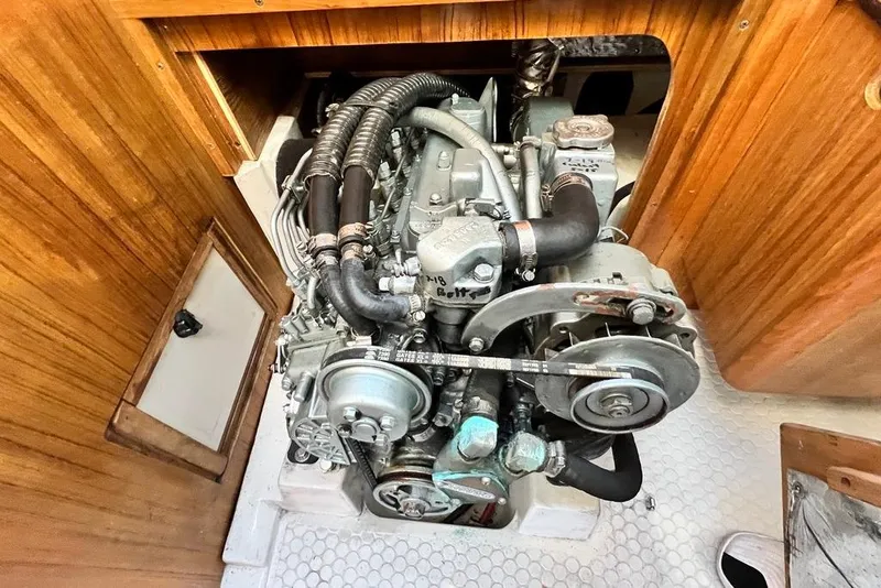 Slide: The Image of Engine compartment of a 1999 Catalina 36 MkII sailboat, showcasing detailed mechanical components. - 52