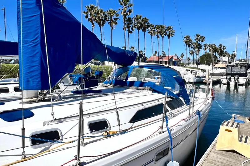 Slide: The Image of 1999 Catalina 36 MkII sailboat docked in sunny marina with palm trees. - 6