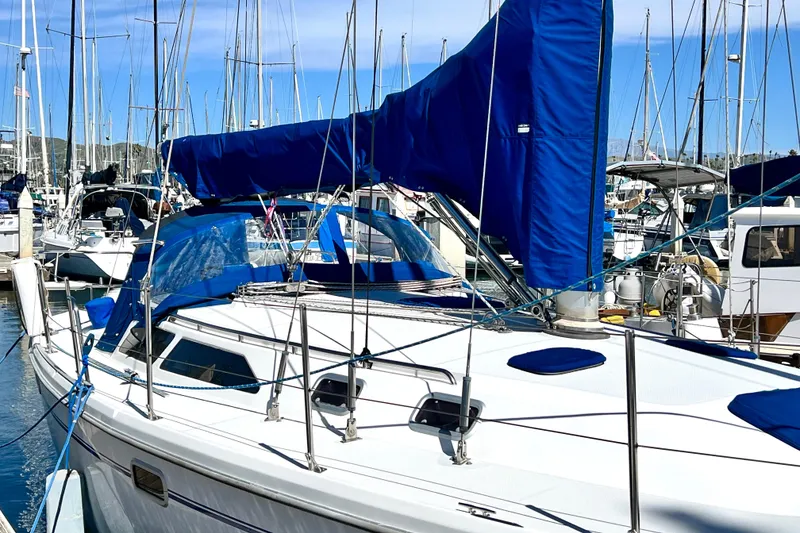 Slide: The Image of 1999 Catalina 36 MkII sailboat docked in a marina, featuring blue sail covers. - 7
