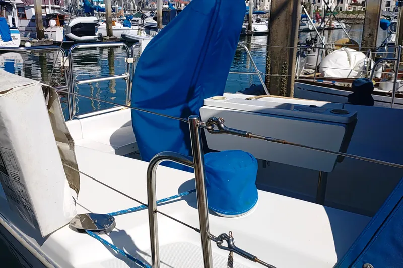 Slide: The Image of 1999 Catalina 36 MkII sailboat cockpit with blue covers, docked in a marina. - 8