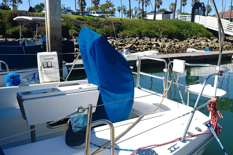 Slide: The Image of 1999 Catalina 36 MkII sailboat docked, featuring covered equipment and lifebuoy. - 9