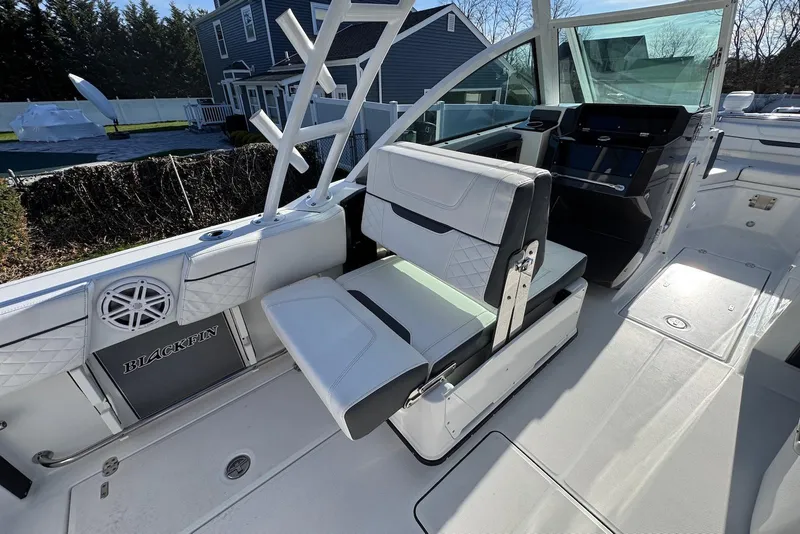 Slide: The Image of 2021 Blackfin 252 DC boat interior with white seating and helm station. - 13
