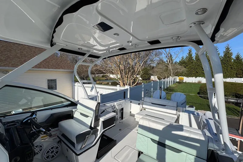 Slide: The Image of 2021 Blackfin 252 DC boat interior with seating and helm, showcasing modern design. - 16