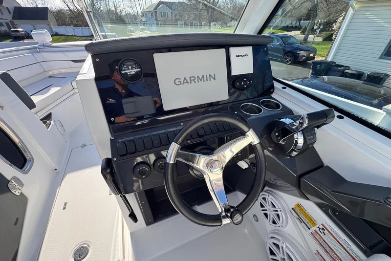 Slide: The Image of 2021 Blackfin 252 DC boat helm with Garmin navigation system and steering wheel. - 17