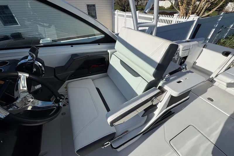 Slide: The Image of 2021 Blackfin 252 DC boat interior with steering wheel and seating area. - 19
