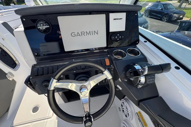 Slide: The Image of 2021 Blackfin 252 DC boat dashboard with Garmin display and Mercury controls. - 20