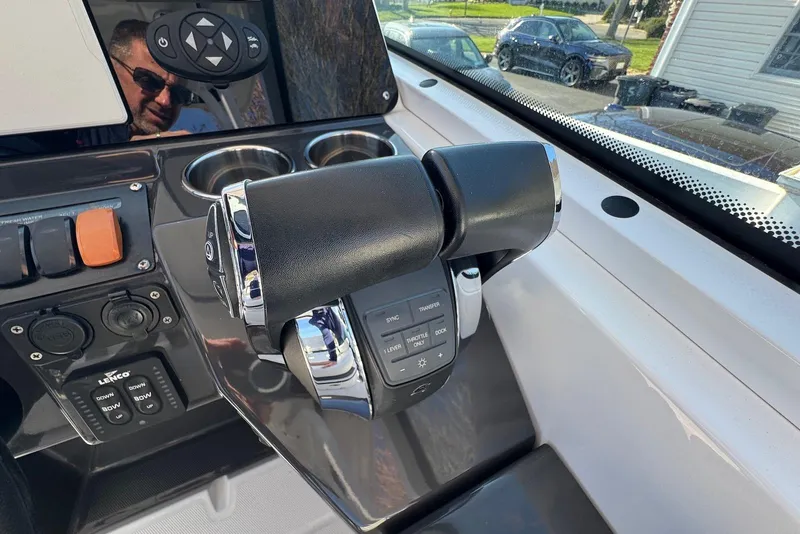 Slide: The Image of 2021 Blackfin 252 DC boat throttle controls and dashboard with cup holders. - 21