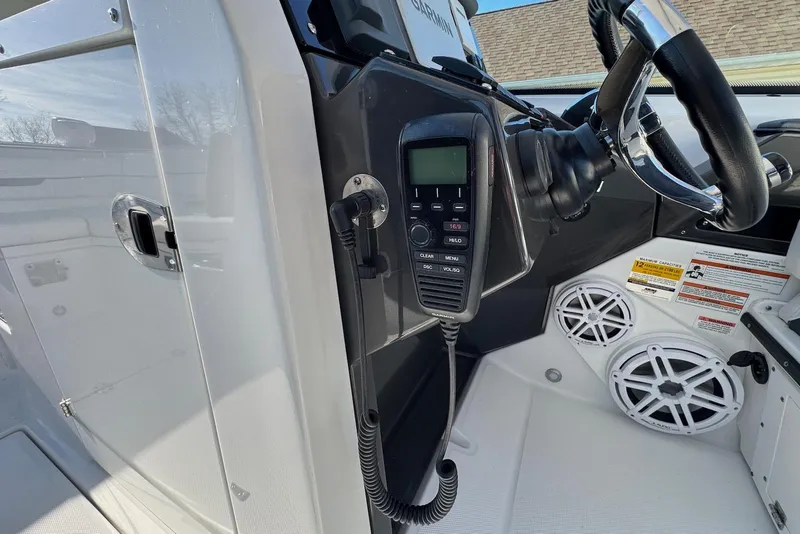 Slide: The Image of 2021 Blackfin 252 DC boat dashboard with radio, steering wheel, and speakers. - 22