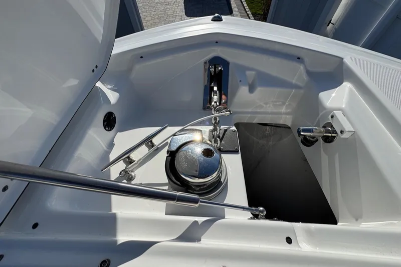 Slide: The Image of Anchor compartment of 2021 Blackfin 252 DC boat, featuring winch and cleats. - 24