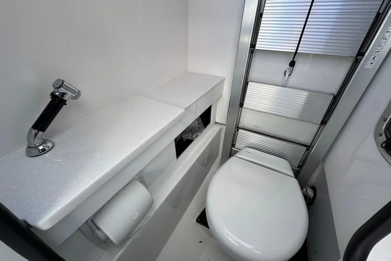 Slide: The Image of 2021 Blackfin 252 DC boat bathroom with toilet and compact design. - 27