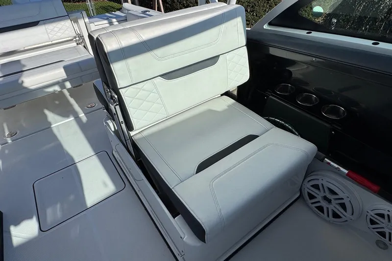 Slide: The Image of 2021 Blackfin 252 DC boat interior with cushioned seating and cup holders. - 29