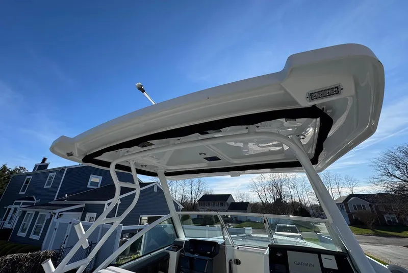 Slide: The Image of 2021 Blackfin 252 DC boat with T-top and Garmin electronics under clear blue sky. - 31