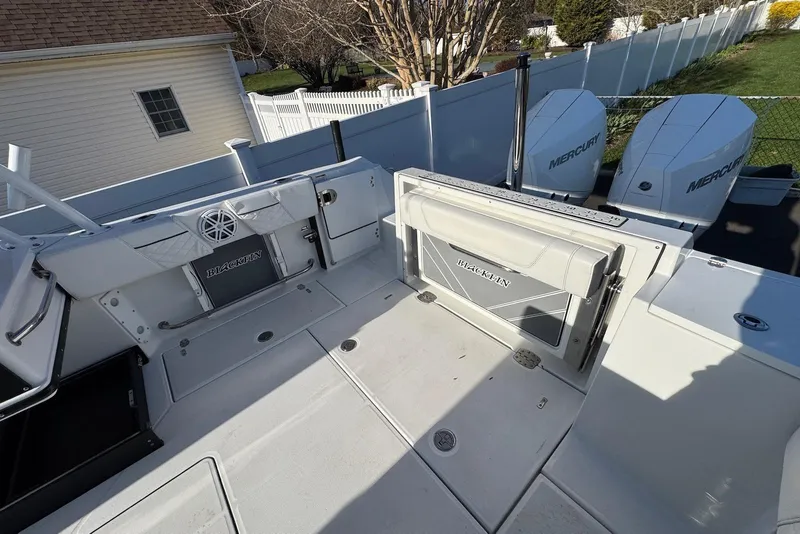 Slide: The Image of 2021 Blackfin 252 DC boat deck with Mercury engines, featuring spacious seating and storage. - 35