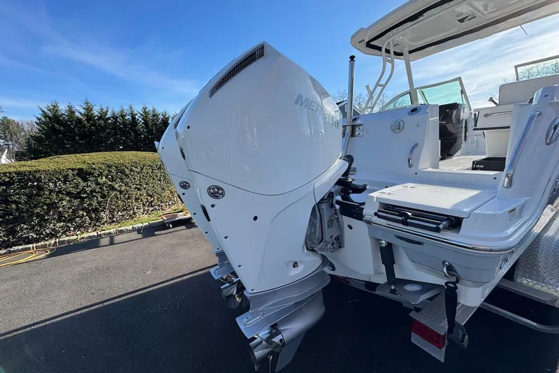 Slide: The Image of 2021 Blackfin 252 DC boat with Mercury outboard motor, parked on a sunny day. - 37