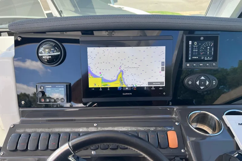 Slide: The Image of 2021 Blackfin 252 DC dashboard with Garmin navigation and control systems. - 4