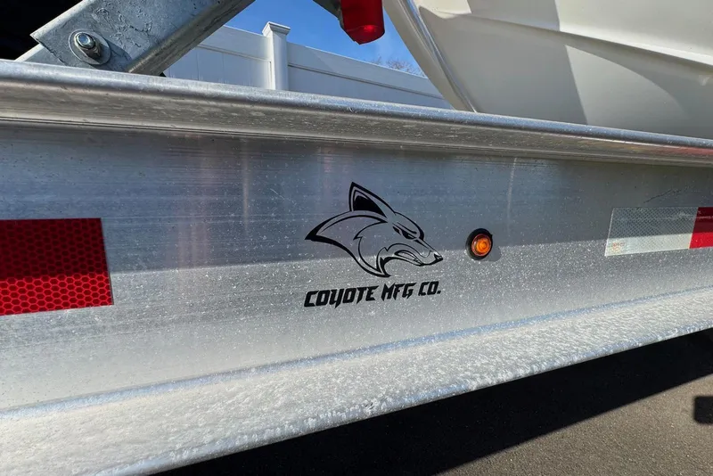 Slide: The Image of Trailer with Coyote MFG Co. logo, part of a 2021 Blackfin 252 DC boat. - 43