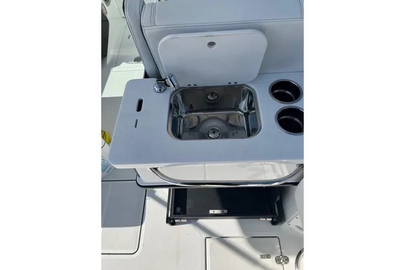 Slide: The Image of 2021 Blackfin 252 DC boat sink and cup holders on deck. - 9