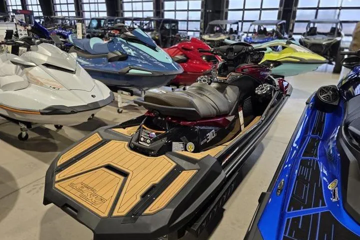 Slide: The Image of 2026 Kawasaki Jetski Ultra 310LX in showroom, surrounded by various personal watercraft models. - 5