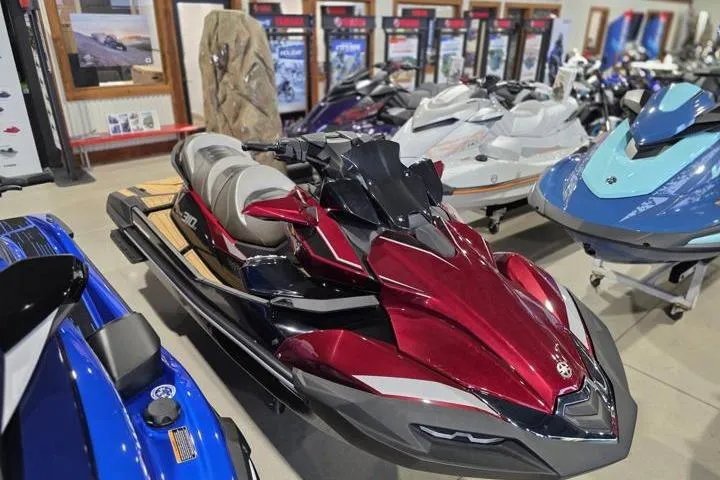 Slide: The Image of 2026 Kawasaki Jetski Ultra 310LX in showroom, sleek red design, surrounded by other watercraft. - 7