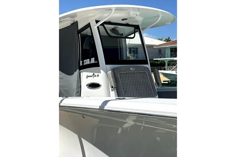 Slide: The Image of 2025 Sea Hunt Gamefish 28 Forward Seating boat, sleek design, docked under clear blue sky. - 3