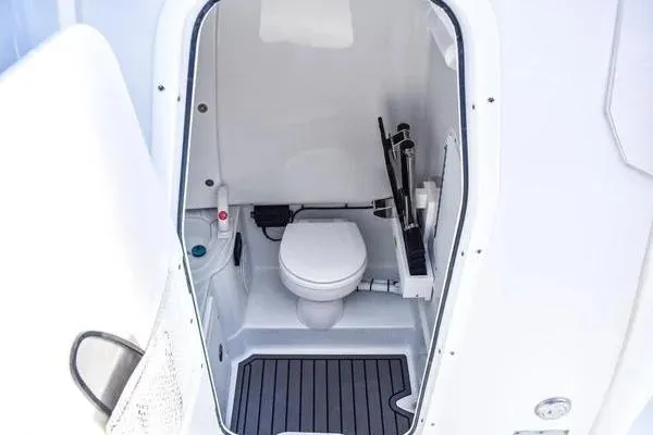 Slide: The Image of 2025 Sea Hunt Gamefish 28 Forward Seating boat interior with compact marine toilet. - 6