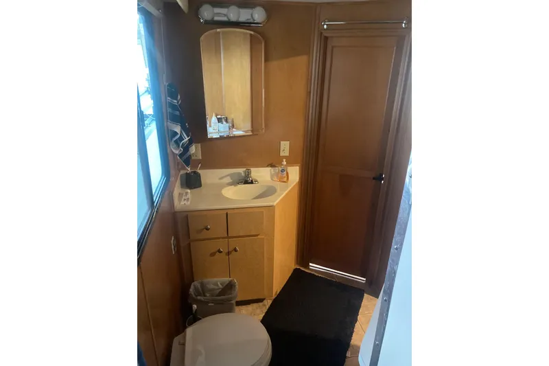 Slide: The Image of Compact bathroom in 2006 Gibson 44, featuring sink, mirror, and wooden cabinetry. - 10