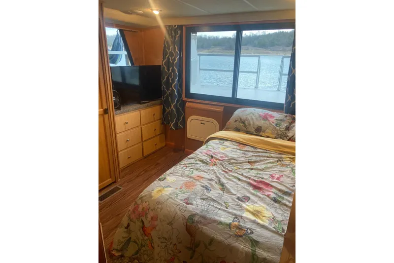 Slide: The Image of Cozy bedroom in 2006 Gibson 44 boat with floral bedding and waterfront view. - 12