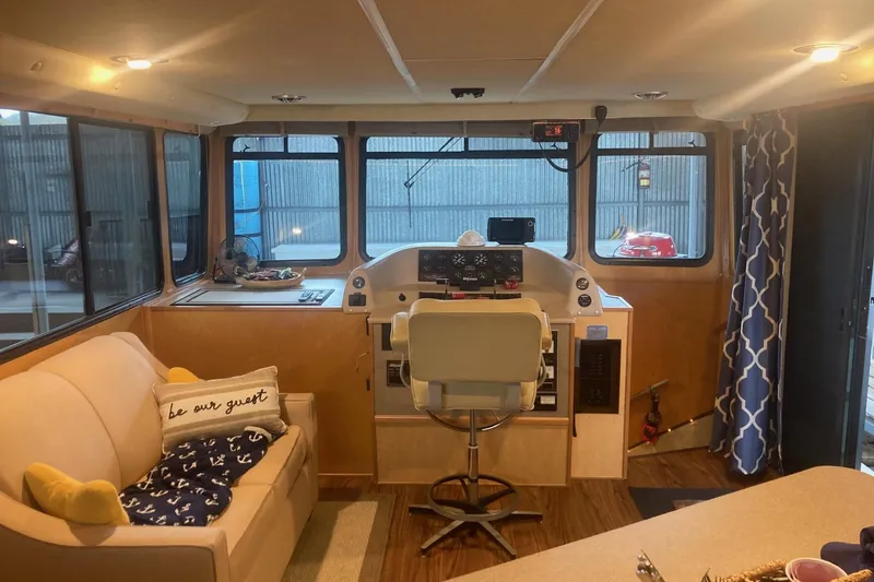 Slide: The Image of Interior of a 2006 Gibson 44 boat with helm, sofa, and nautical decor. - 13