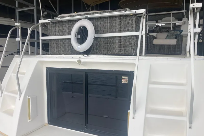 Slide: The Image of Gibson 44 boat rear view with life ring and sliding glass doors, 2006 model. - 5