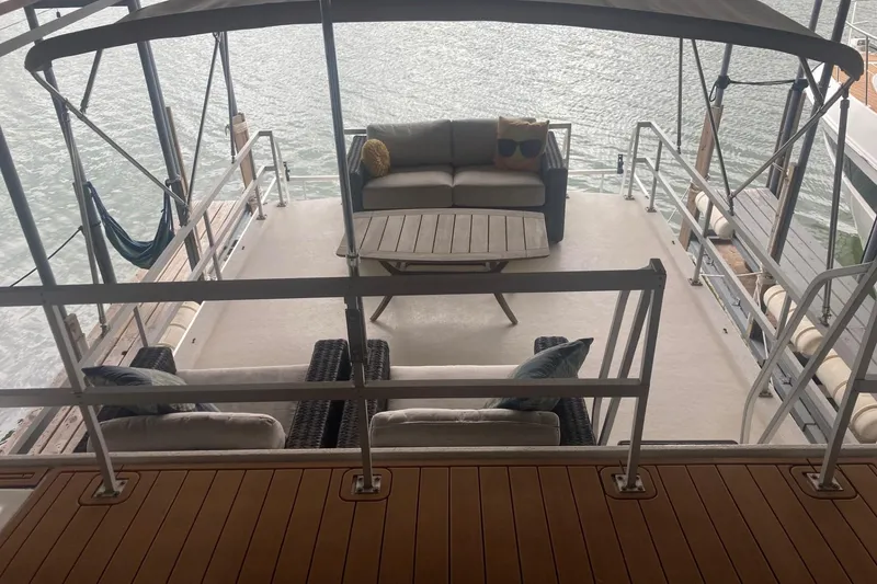 Slide: The Image of Spacious deck of 2006 Gibson 44 houseboat with outdoor seating and hammock. - 8