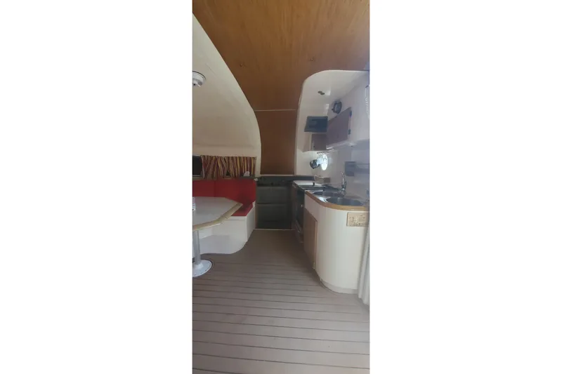 Slide: The Image of Interior of 1992 Fountaine Pajot Ninou yacht with kitchen and seating area. - 15