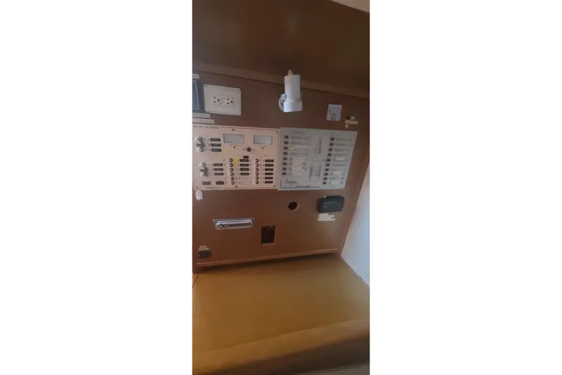 Slide: The Image of Control panel inside 1992 Fountaine Pajot Ninou yacht, featuring switches and outlets. - 24