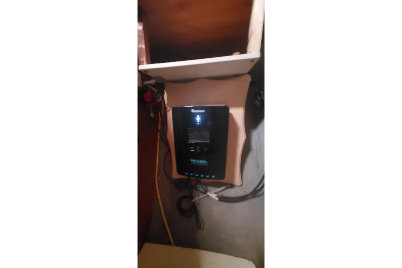 Slide: The Image of Electrical panel inside 1992 Fountaine Pajot Ninou boat, featuring a Renogy Rover charge controller. - 27