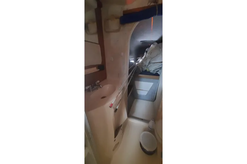 Slide: The Image of Interior of 1992 Fountaine Pajot Ninou sailboat, featuring compact bathroom and storage area. - 35
