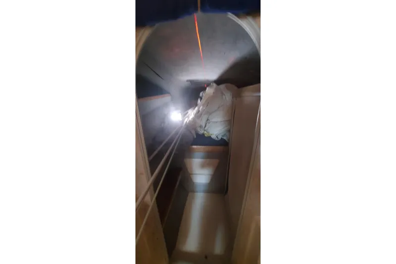 Slide: The Image of Interior view of 1992 Fountaine Pajot Ninou sailboat, showing storage area with ropes and equipment. - 40