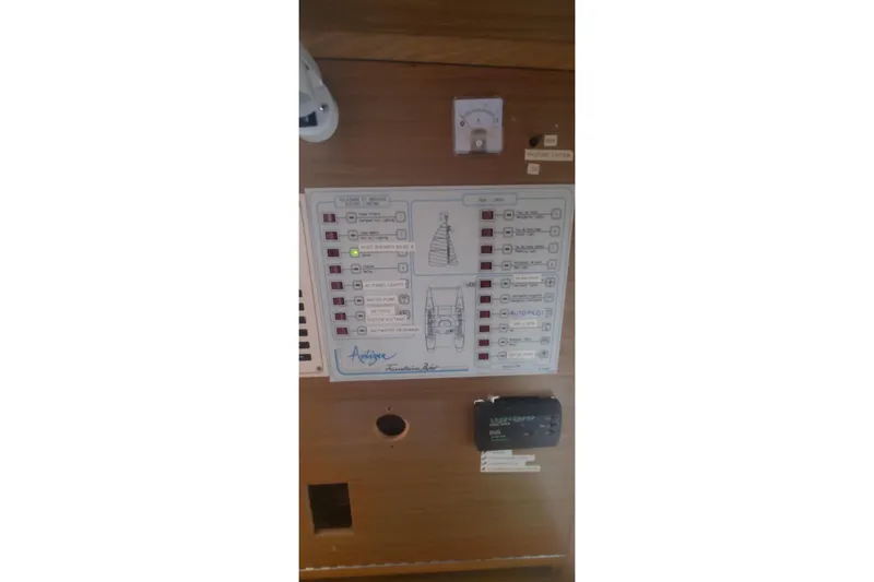 Slide: The Image of Control panel of 1992 Fountaine Pajot Ninou yacht with labeled switches and indicators. - 43