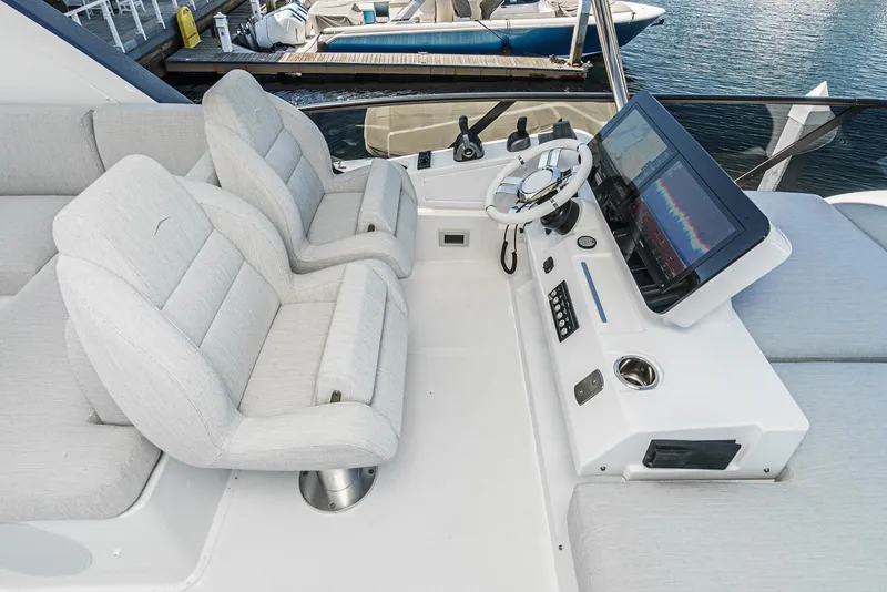 Slide: The Image of 2024 Azimut Fly 53 yacht helm with dual seats and modern navigation system. - 14