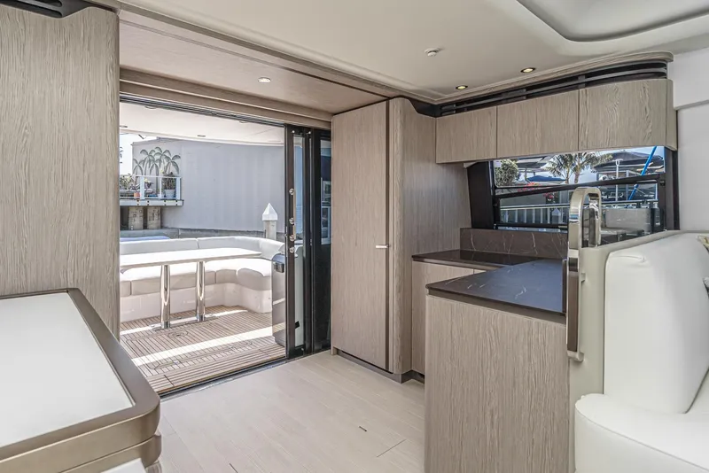 Slide: The Image of 2024 Azimut Fly 53 yacht interior with modern kitchen and outdoor seating area. - 26