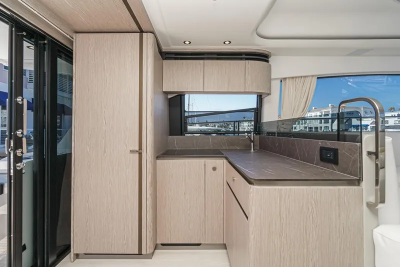 Slide: The Image of Modern kitchen interior of 2024 Azimut Fly 53 yacht with sleek cabinetry and large windows. - 29