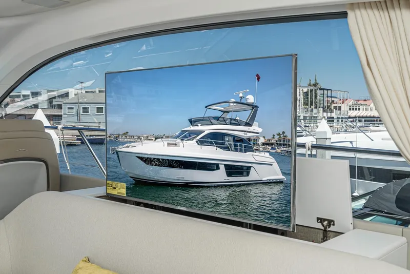 Slide: The Image of 2024 Azimut Fly 53 yacht displayed on a screen inside a luxurious cabin. - 38