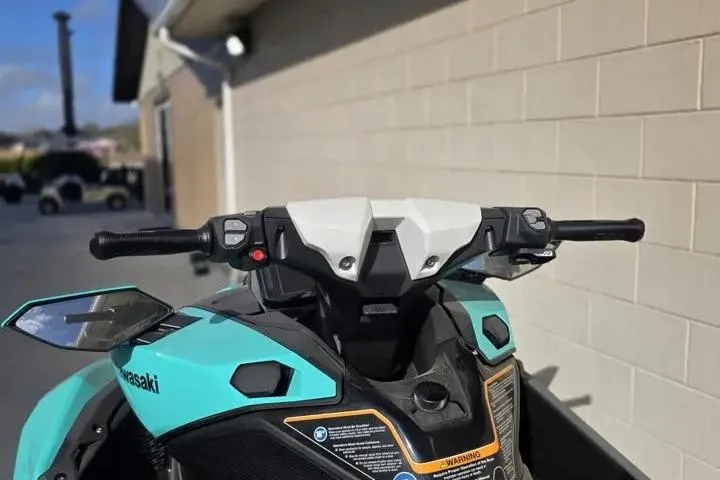 Slide: The Image of 2026 Kawasaki Jetski Ultra 310LX-S handlebars and dashboard, turquoise and black design. - 10