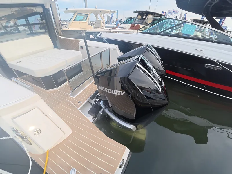 Slide: The Image of The image shows a modern boat with twin Mercury outboard engines in the water. - 6