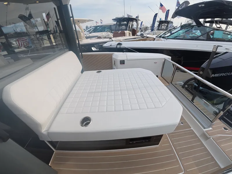 Slide: The Image of The image shows the deck of a 2027 Saxdor 340 GTWA with a white lounging area. - 8