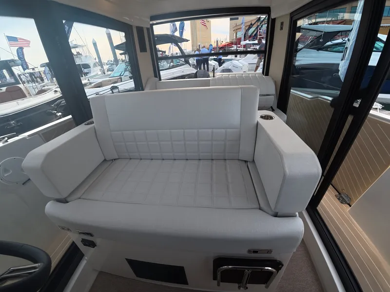 Slide: The Image of The image shows a modern boat cabin with a cushioned bench seat and large windows. - 10