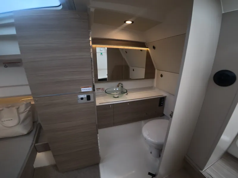 Slide: The Image of Modern boat bathroom with sink, toilet, and wood paneling. - 18
