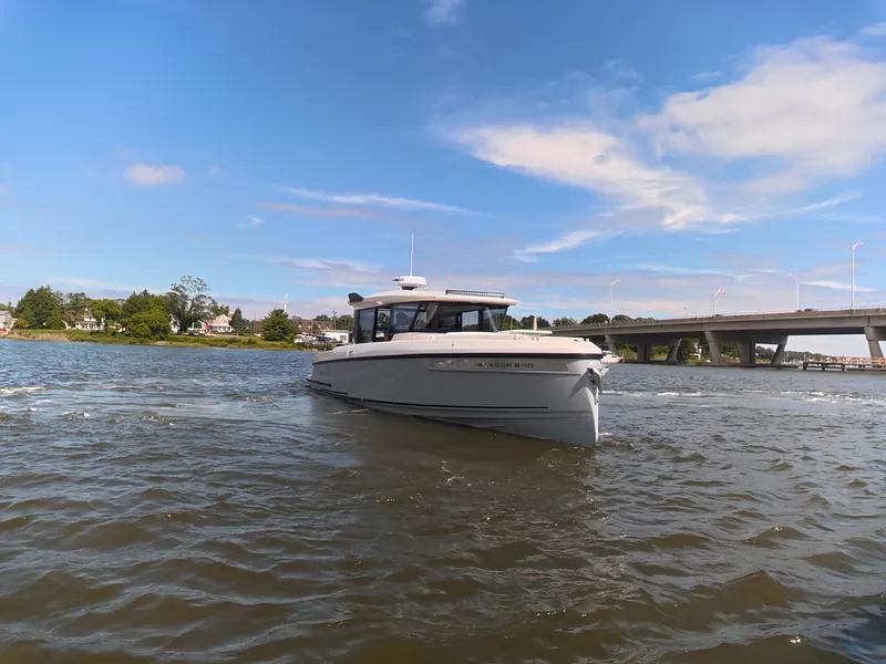 Slide: The Image of A 2027 Saxdor 340 GTWA boat cruising on a river under a blue sky. - 4
